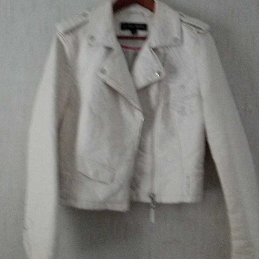 White almost like leather motorcycle jacket unfortunately got some black on it.